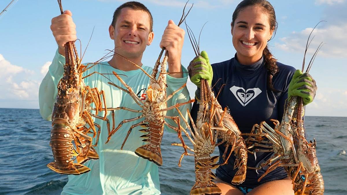 The oceans provide, just ask... Young couple show off 7 lobsters on their sailboat